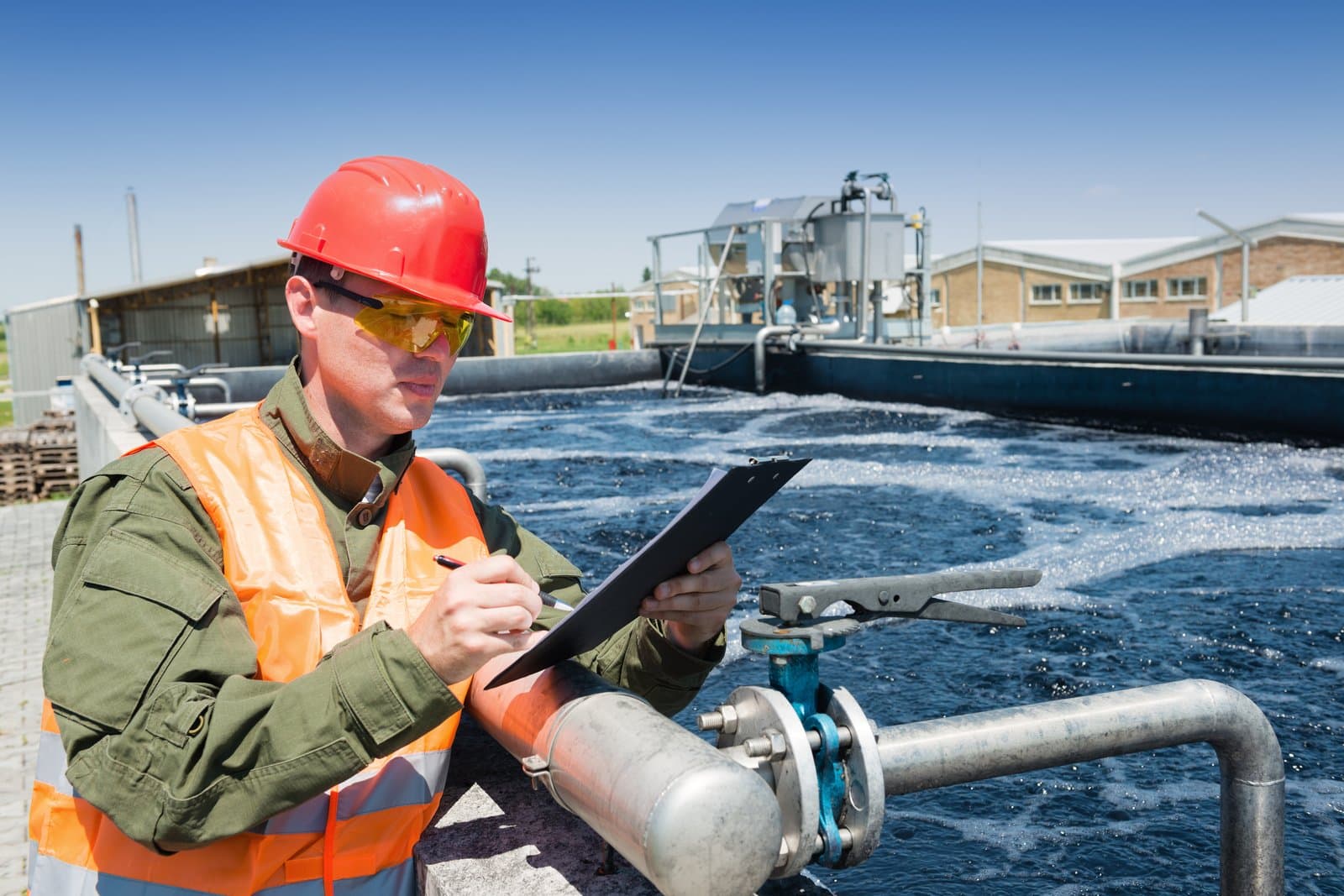 Process engineer recording readings next to a dissolved air flotation basin