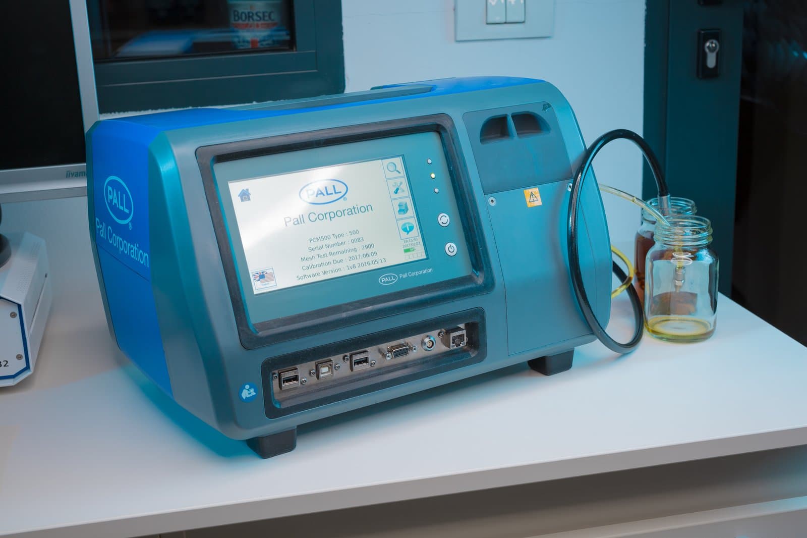 Pall PCM500 particle counter on the Klarwin lab bench, connected to an oil sample bottle for analysis