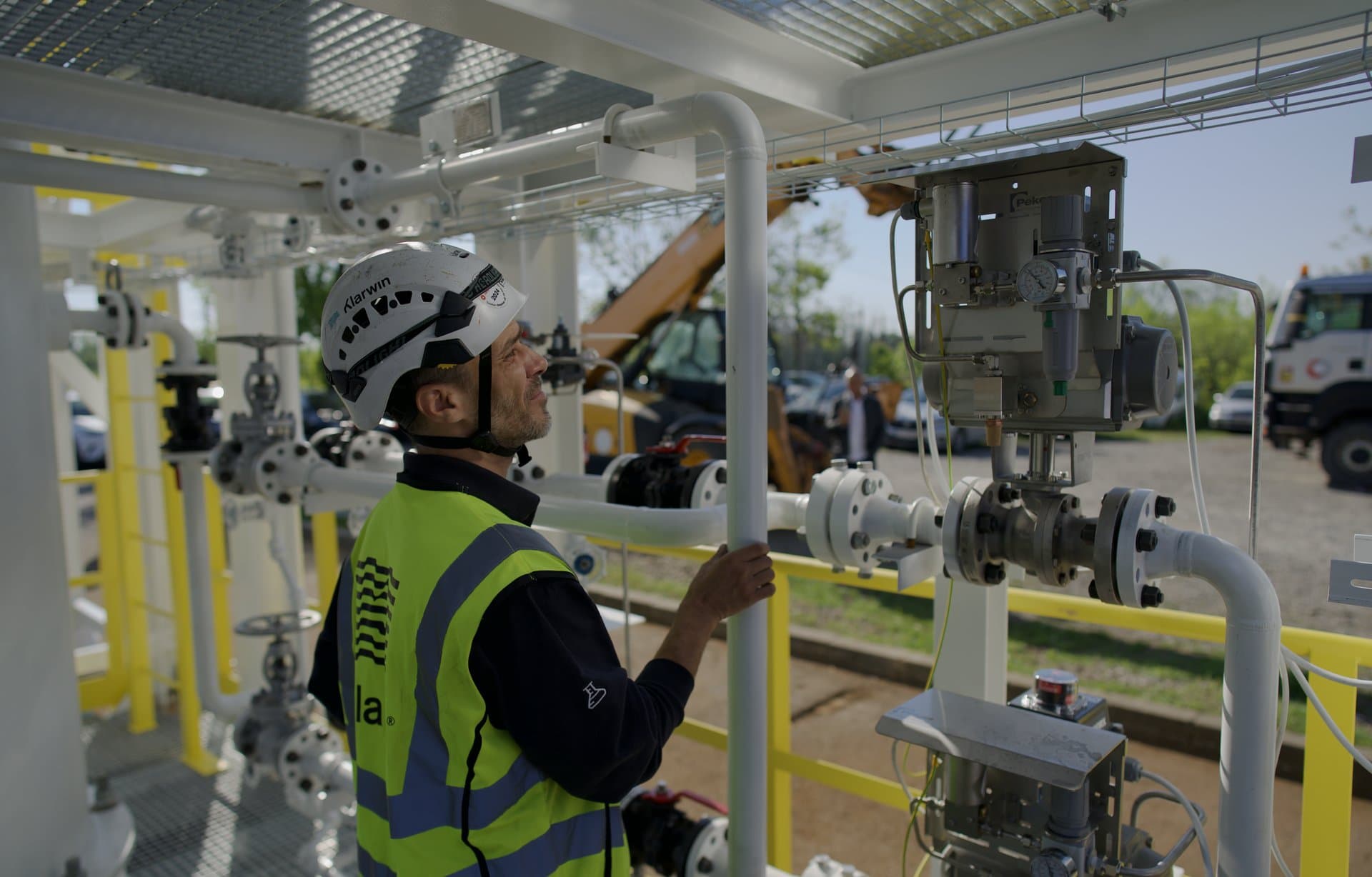 Klarwin field engineer inspecting valves and instrumentation on an industrial process skid