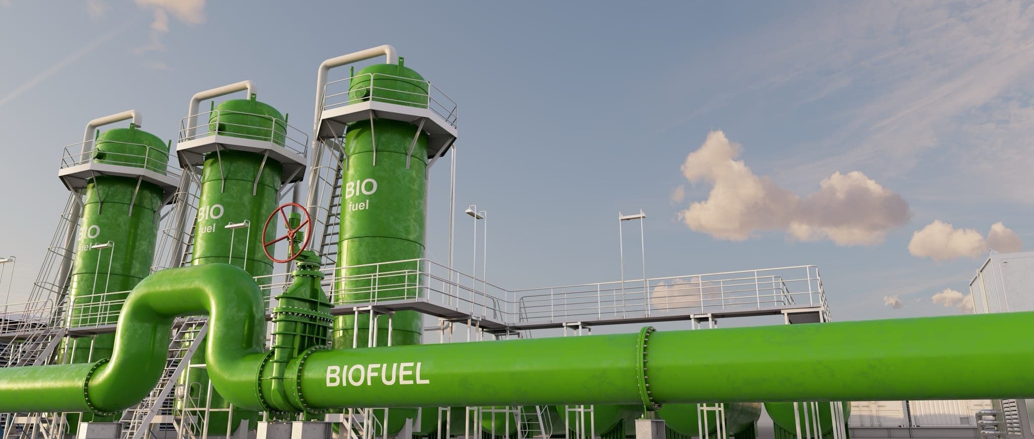Green biofuel storage tanks and pipelines under blue sky