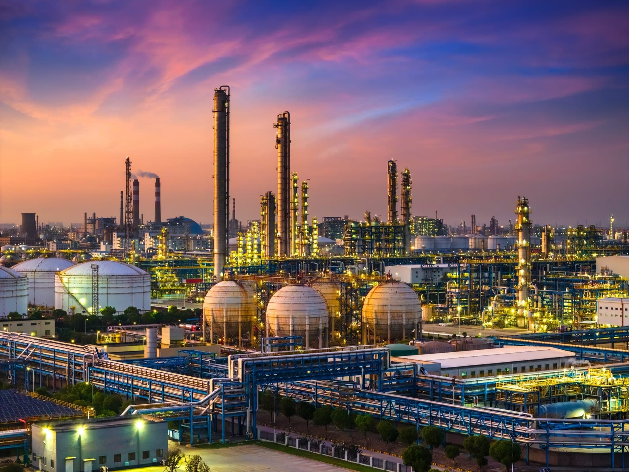 Oil refinery and chemical plant in large industrial area at sunset
