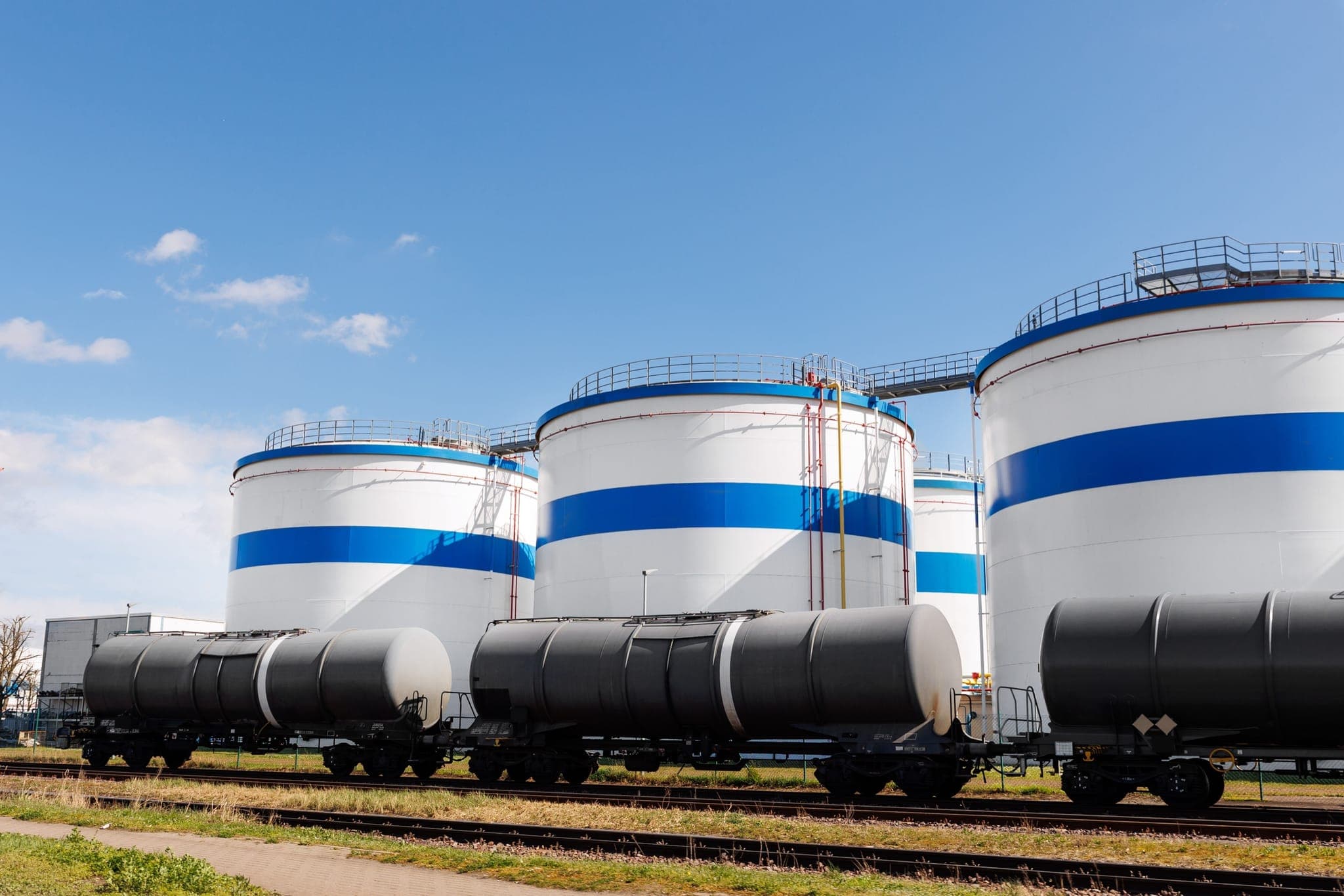 Fuel storage tank farm with rail tanker cars at terminal