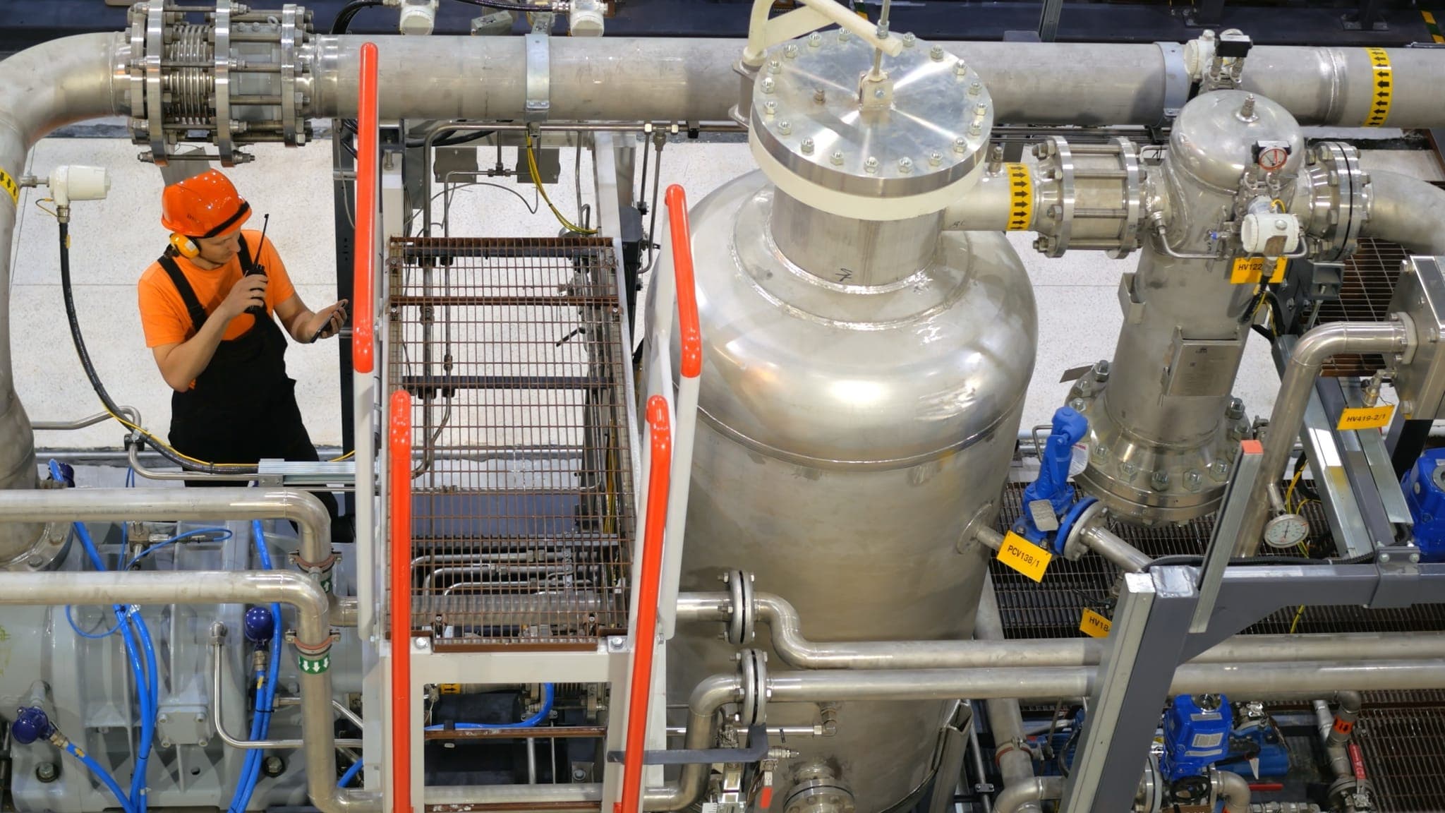 Technician inspecting stainless steel filtration and separation skid