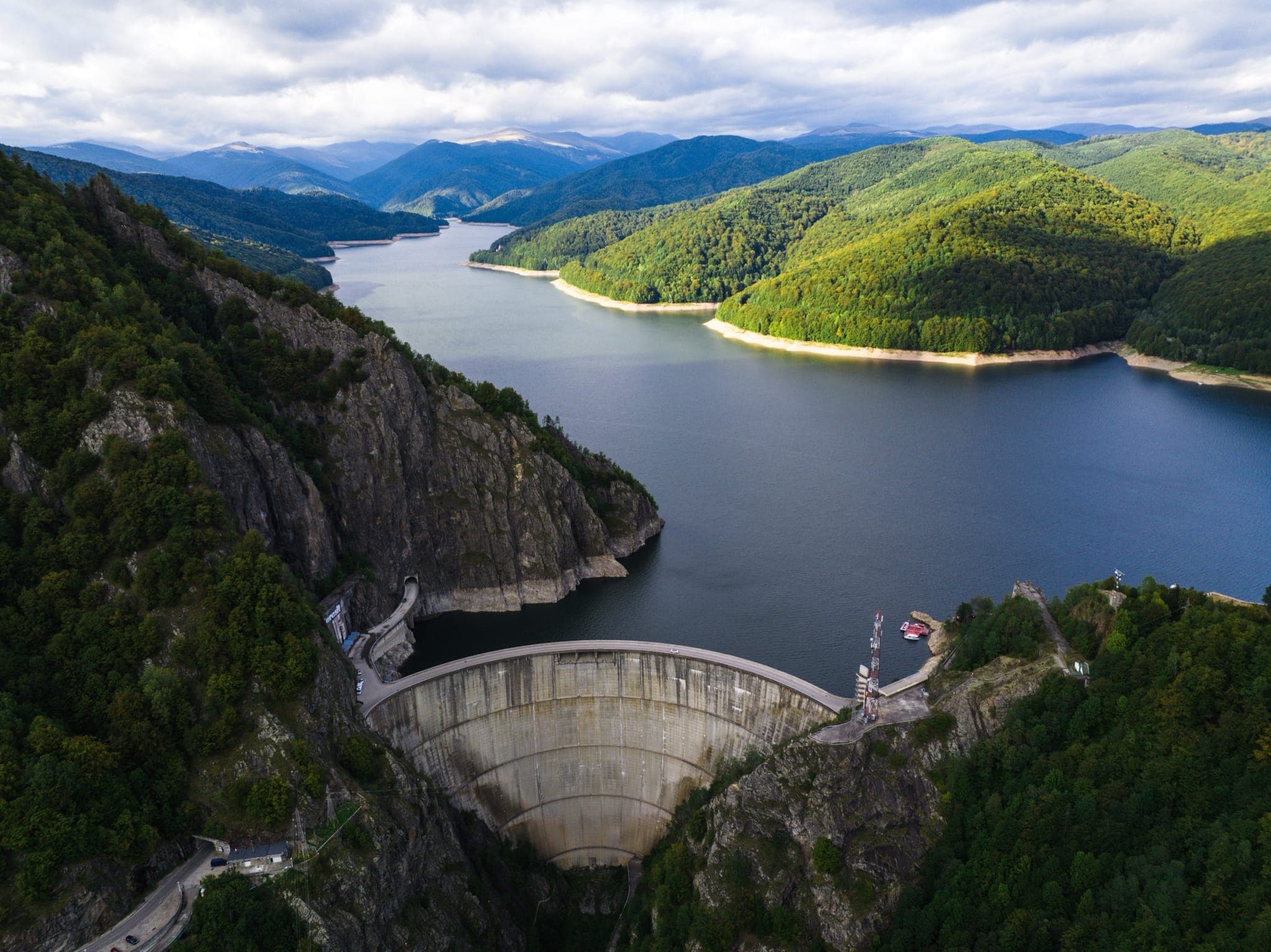 Aerial view of a mountain hydroelectric dam and reservoir