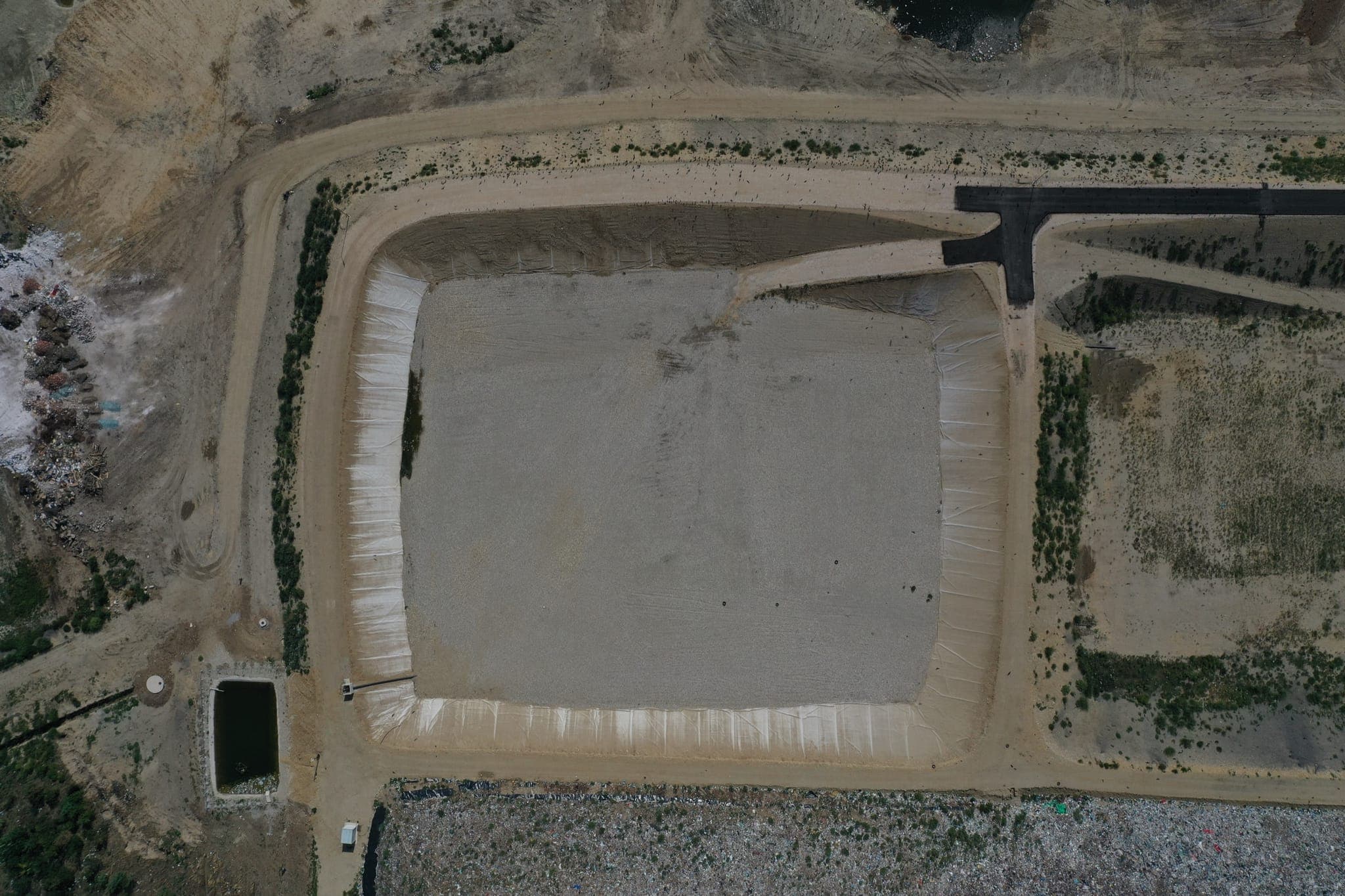 Landfill cell construction site — earthworks and infrastructure installation