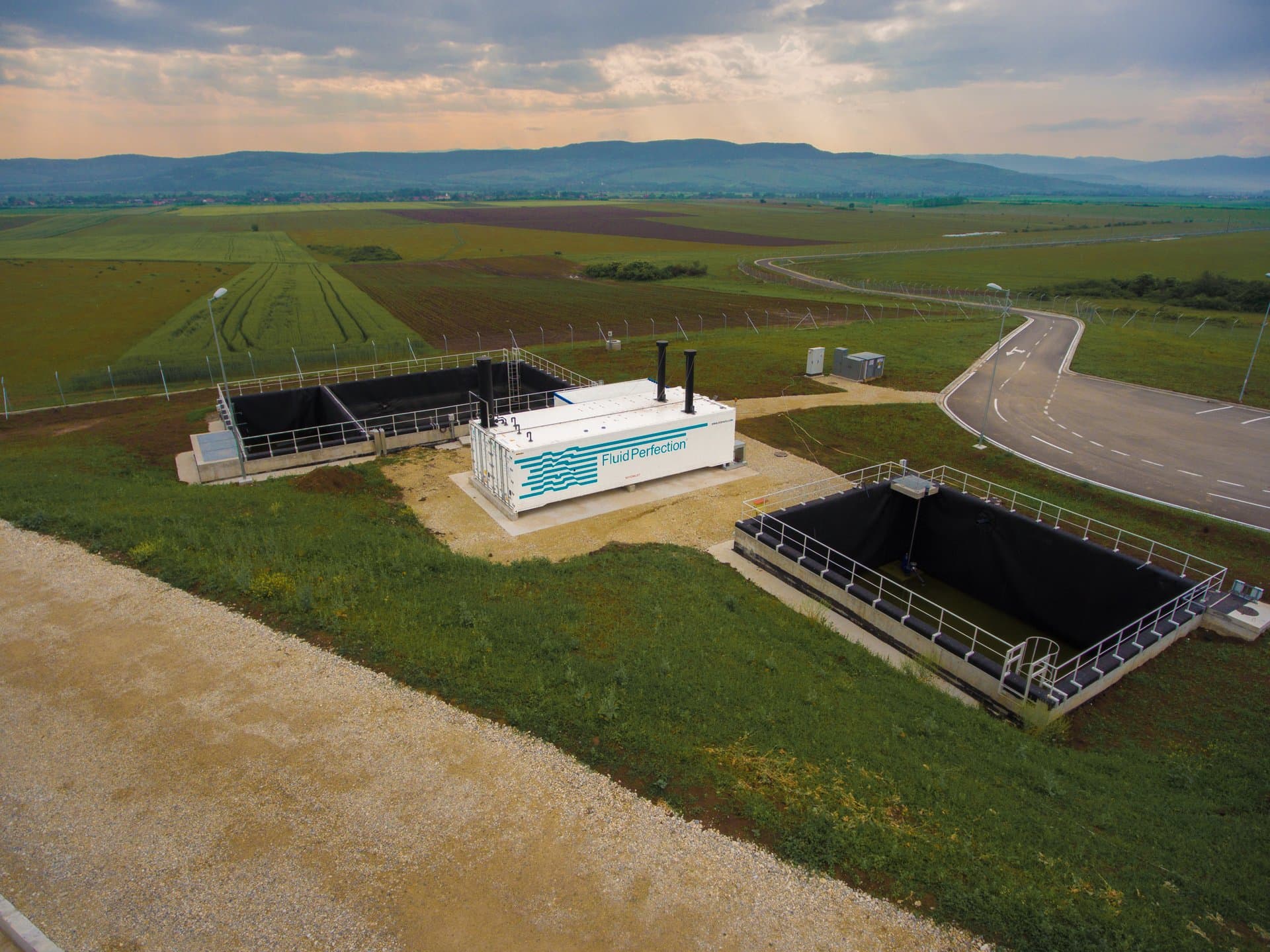 Aerial view of a Klarwin landfill leachate treatment site — Fluid Perfection container with leachate retention ponds, set in open countryside