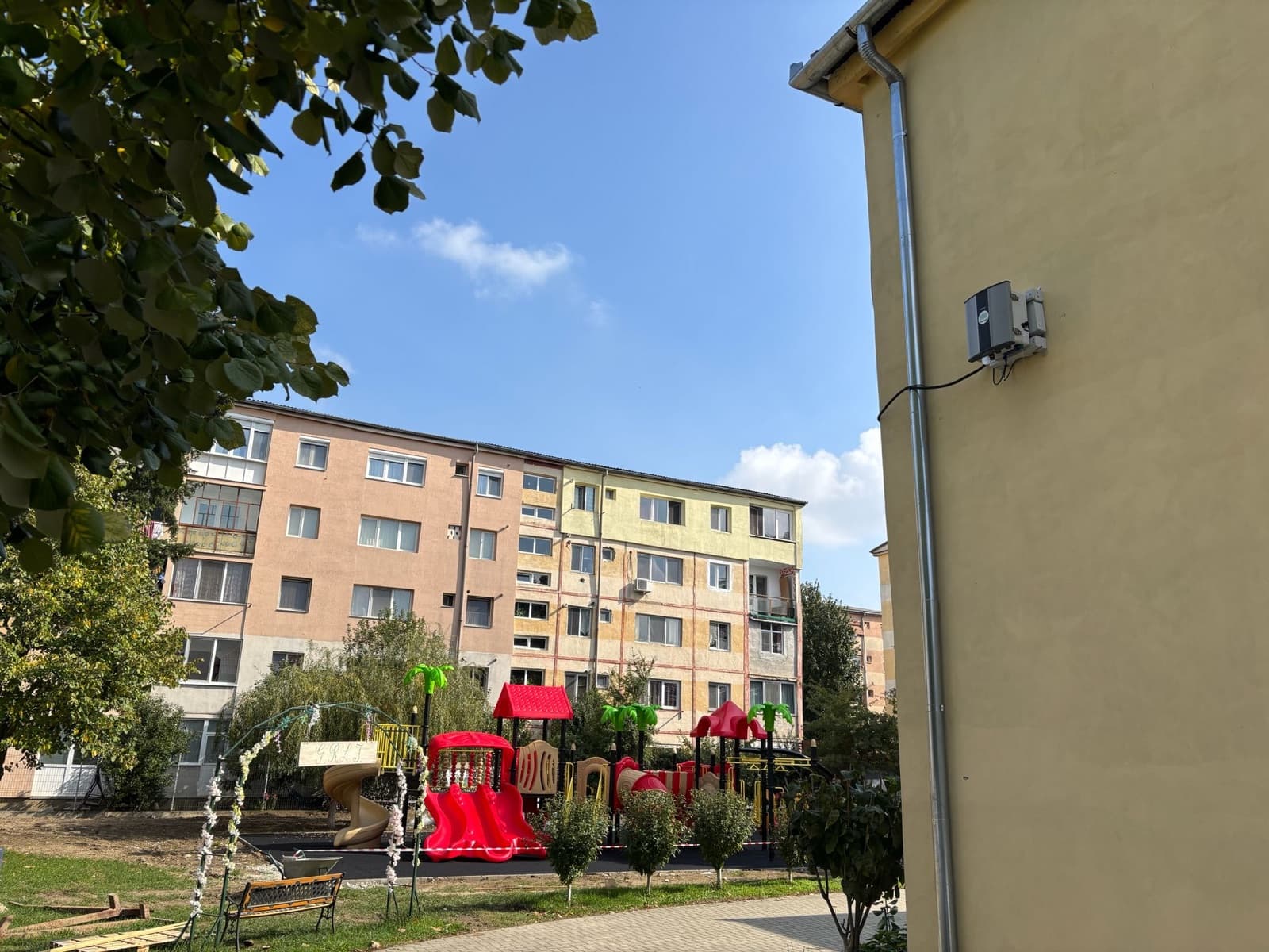 Stație Polludrone pe o clădire rezidențială, cu vedere către blocuri și un loc de joacă pentru copii