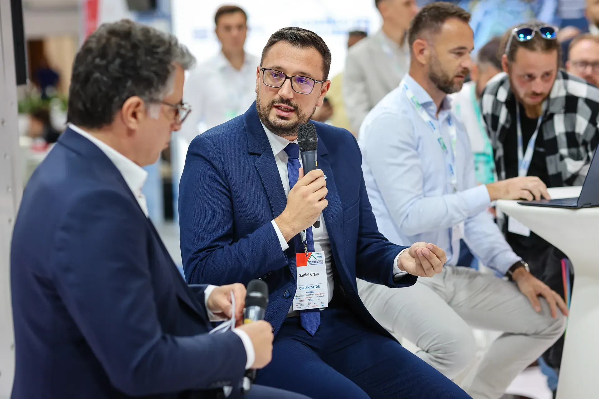 Speakers in dialogue during the G-DEPLOY presentation