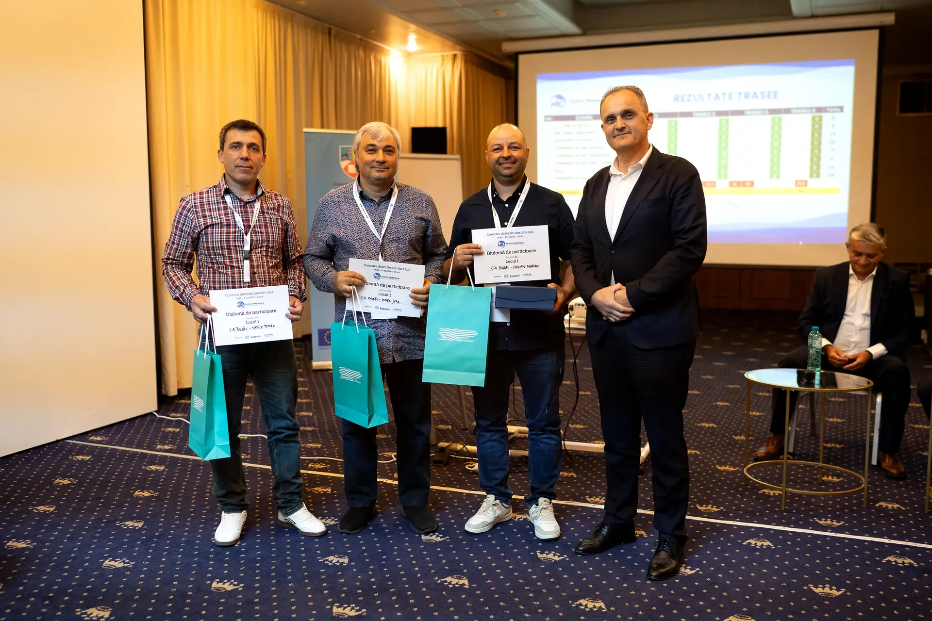 Team members holding their certificates after the award
