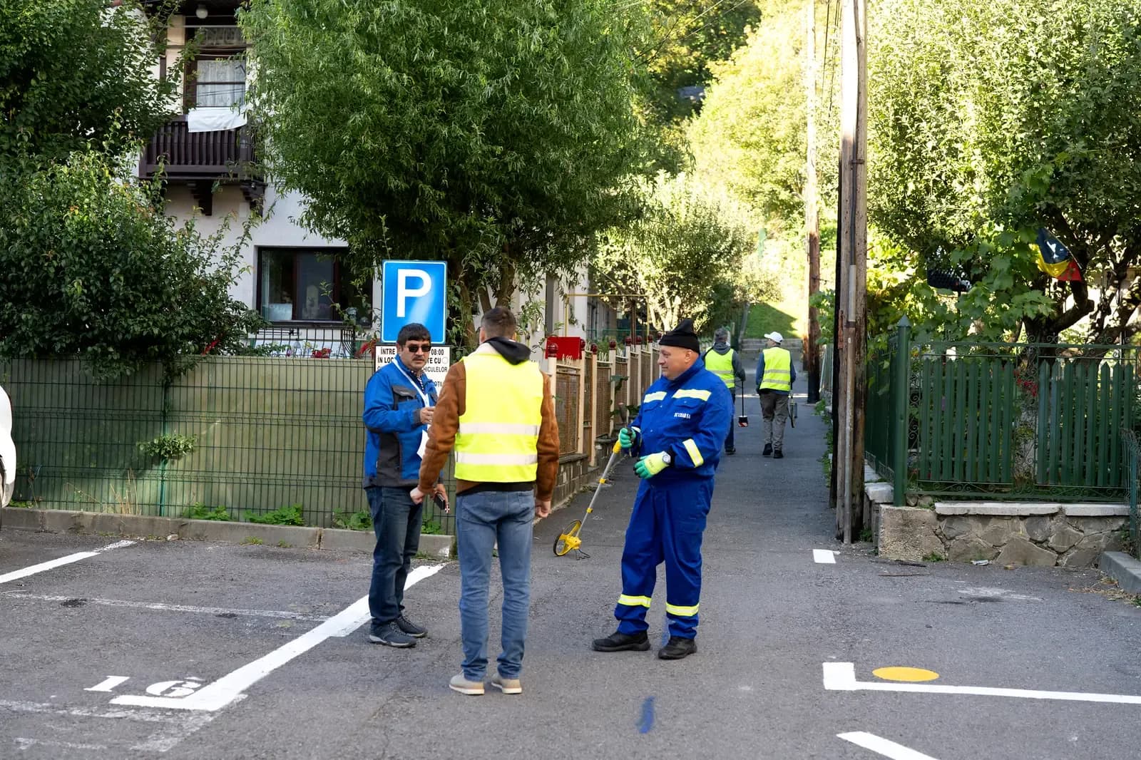 Operators setting out on a route, one carrying the measuring wheel