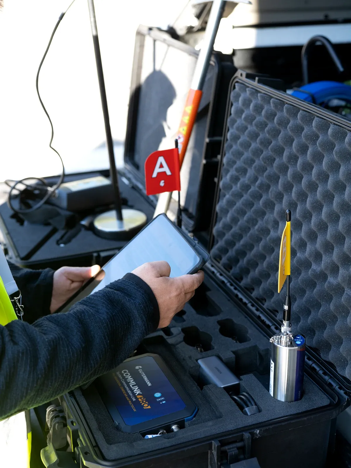 The open equipment case: a Gutermann CommLink Pro, a tablet and a logger ready for the route
