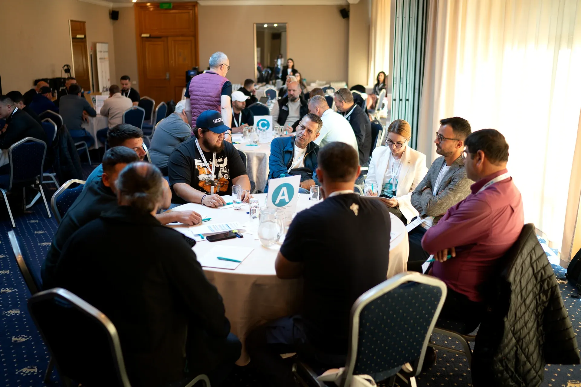 Participants working at round tables A and C during the workshop